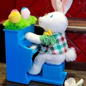 Easter Bunny playing the piano with eggs on the top of the piano and plays music